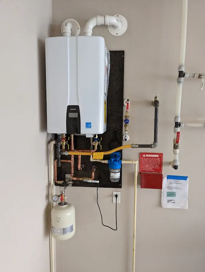 Professional plumber installing copper piping in a Osage home